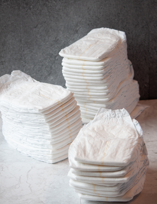 3 stacks of white diapers 
