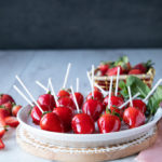 serving platter of candied strawberries garnished with fresh mint