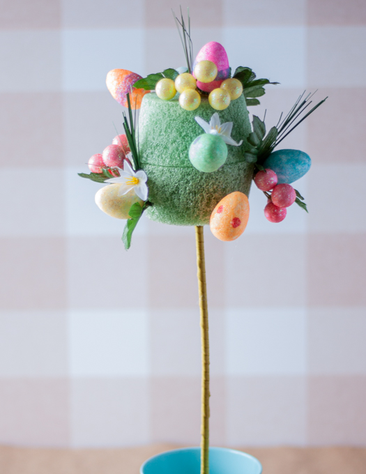 a foam green pot insert with colourful eggs flowers and greenery