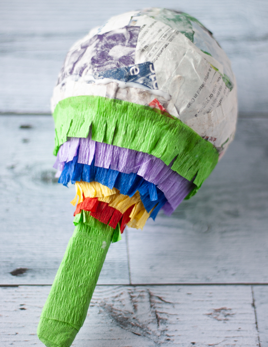 Mini Pinata being covered half way with ruffle crepe paper