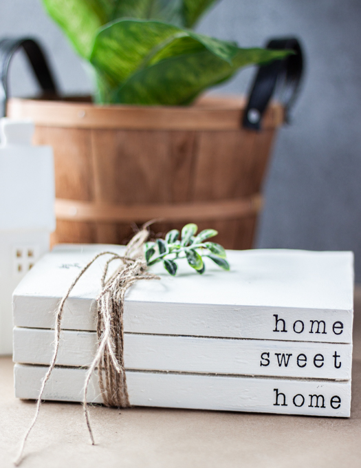 Stamped book stacks 3 books with Home sweet home word wrapped with twin and green stem on top